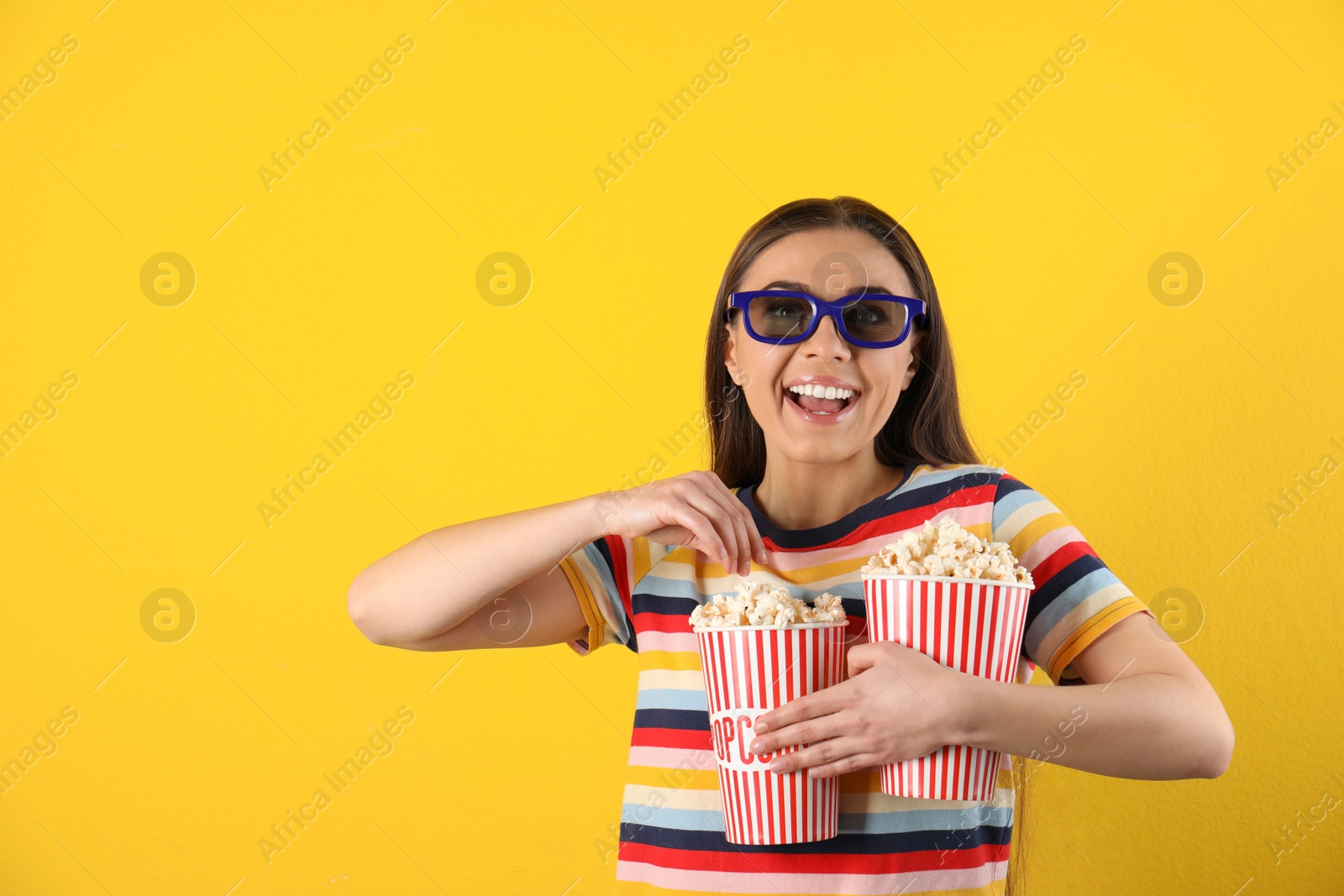 Photo of Young woman with 3D glasses and tasty popcorn on color background