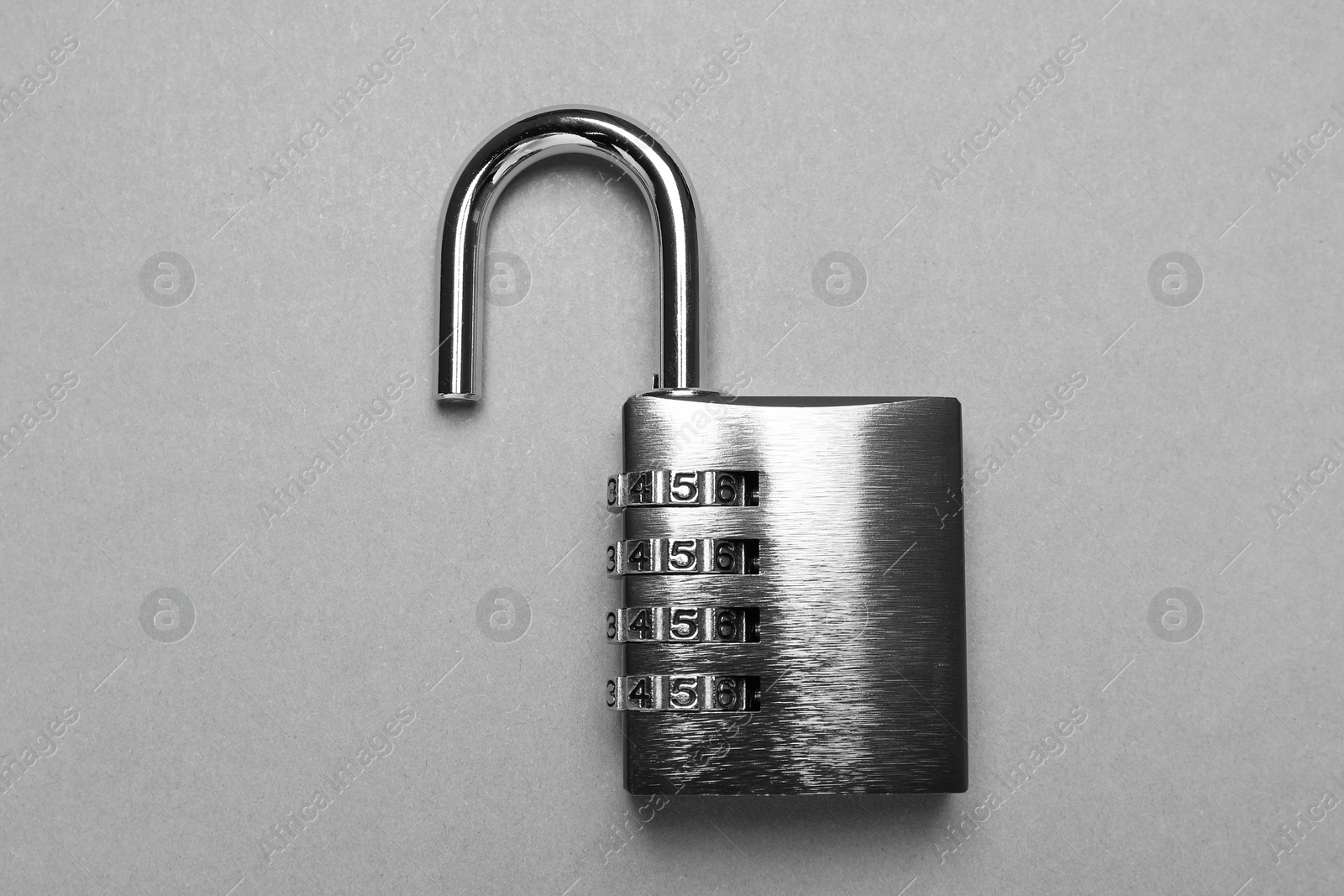 Photo of One steel combination padlock on grey background, top view