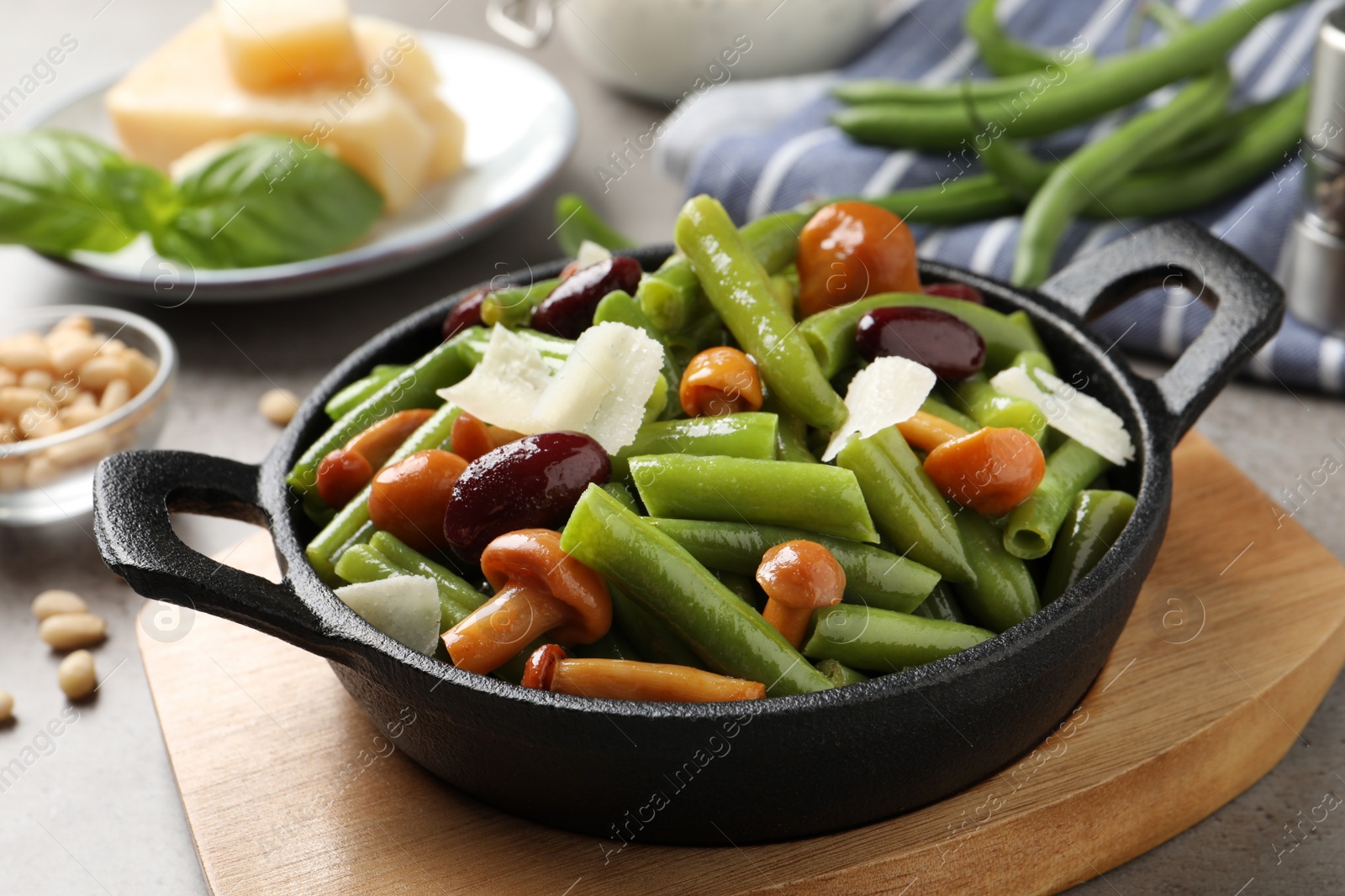 Photo of Delicious salad with green beans, mushrooms and cheese on table, closeup