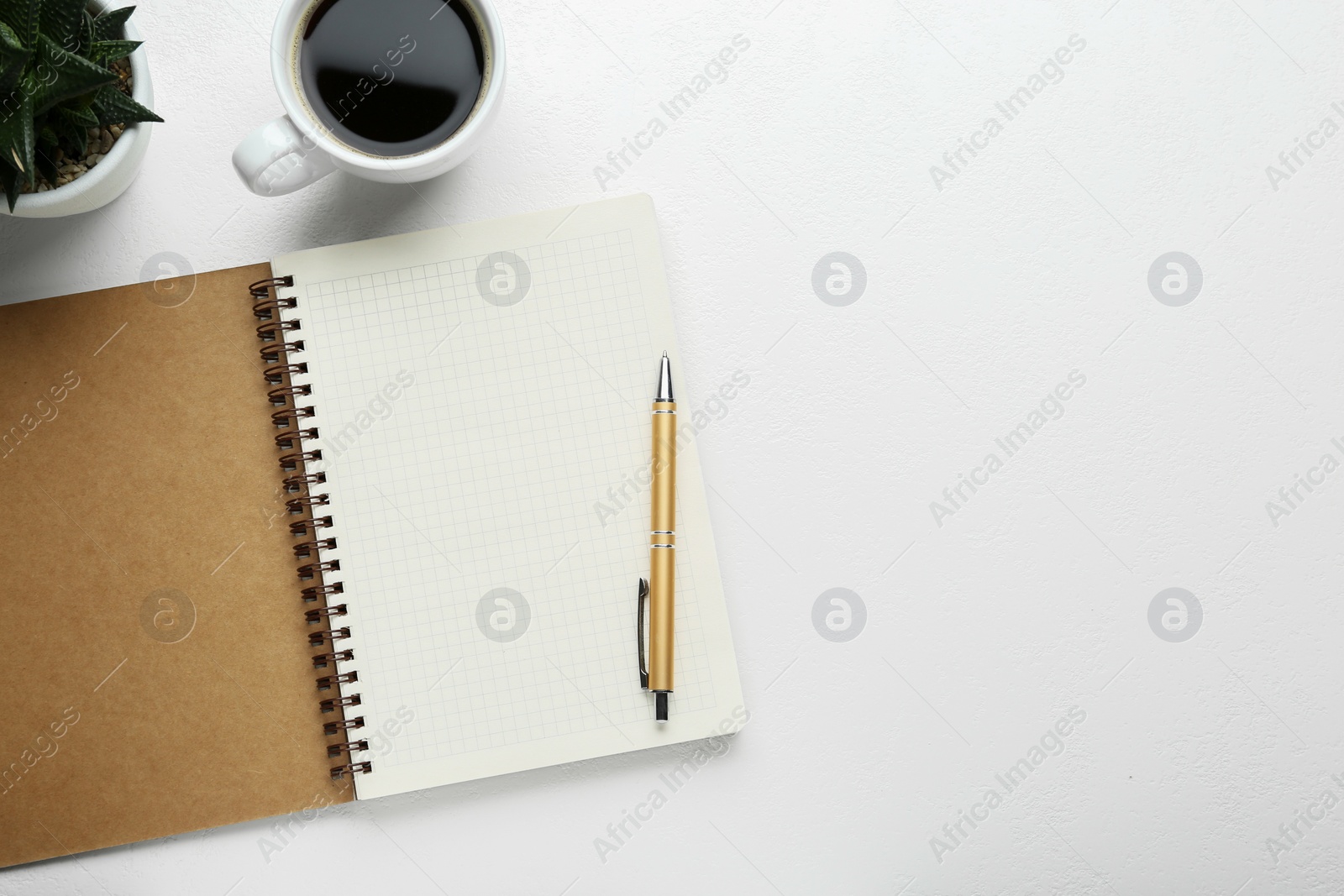 Photo of Flat lay composition with open notebook on white table. Space for text