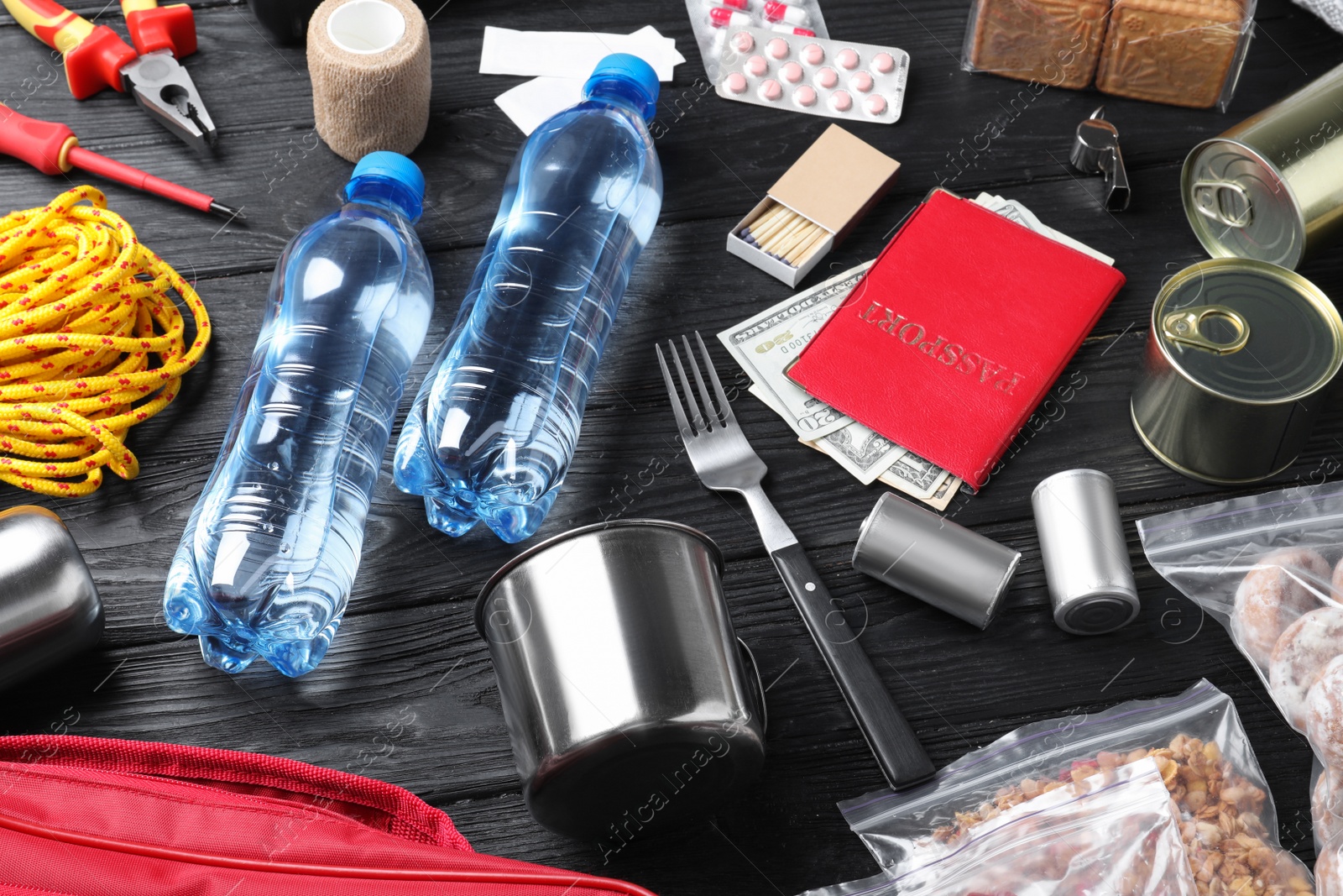 Photo of Disaster supply kit for earthquake on black wooden table