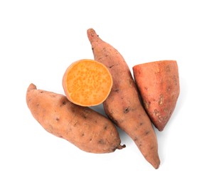 Whole and cut ripe sweet potatoes on white background, top view