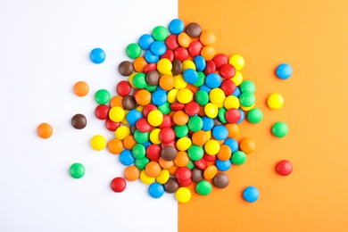 Photo of Glazed candies on color background, top view