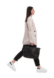 Photo of Beautiful businesswoman in suit with briefcase walking on white background
