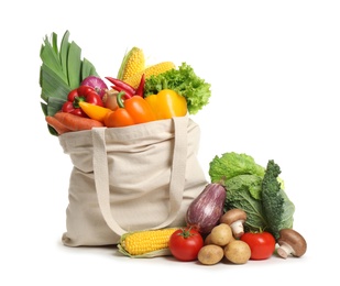 Photo of Shopping bag with fresh vegetables on white background