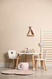 Baby room interior with stylish table, chairs and toys