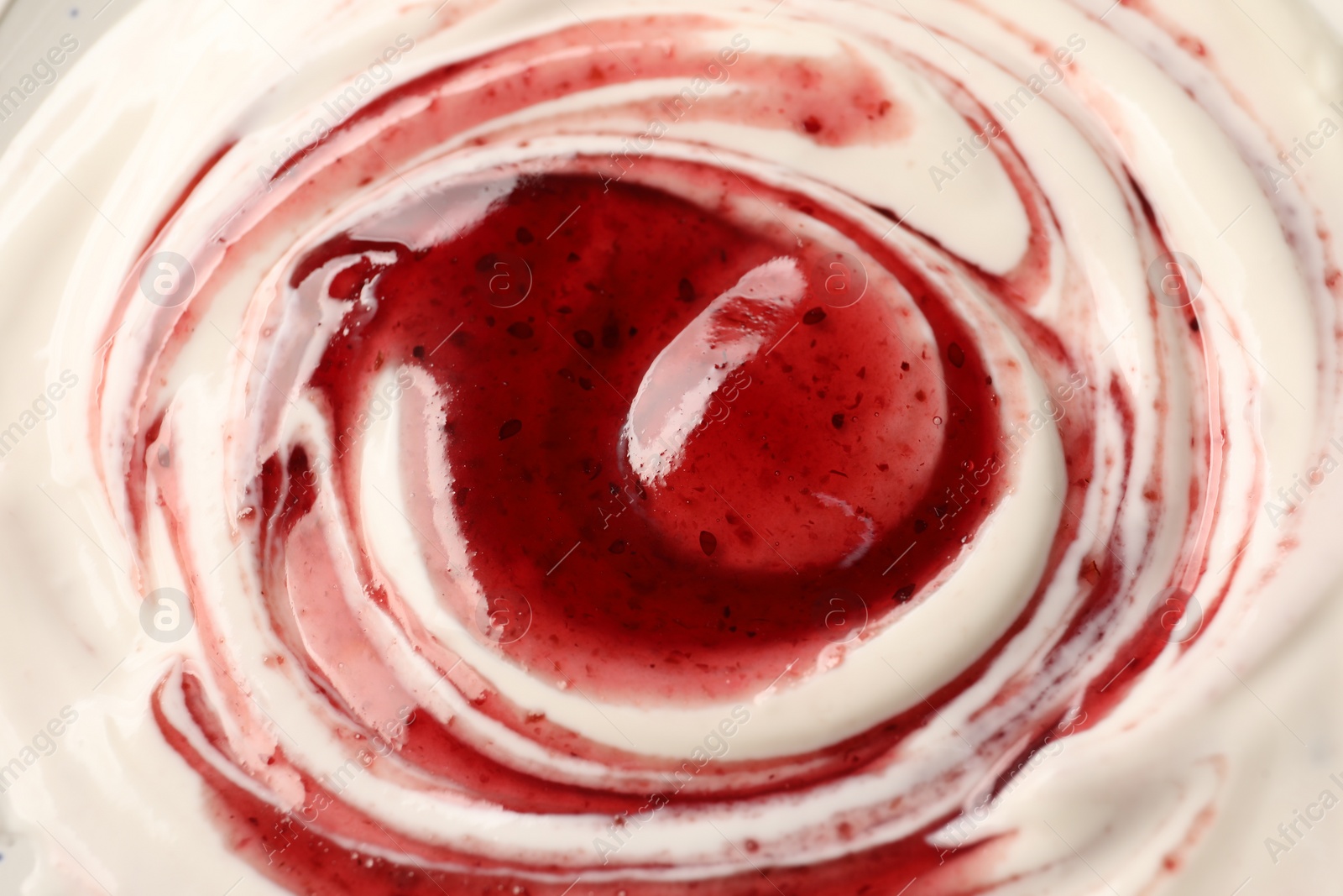 Photo of Tasty yoghurt with jam as background, closeup