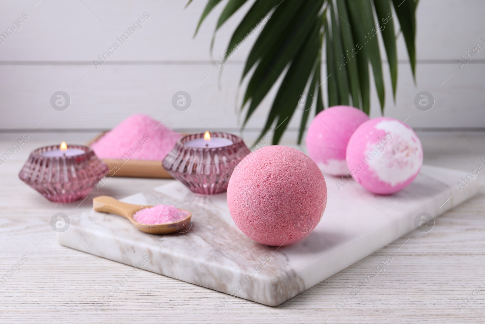 Photo of Beautiful composition with aromatic bath bombs on white wooden table