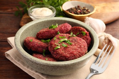 Tasty vegan cutlets served on wooden table, closeup