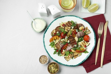 Delicious salad with beef tongue, grilled vegetables, peach and blue cheese on white table, flat lay. Space for text