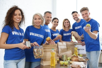Team of volunteers collecting food donations indoors