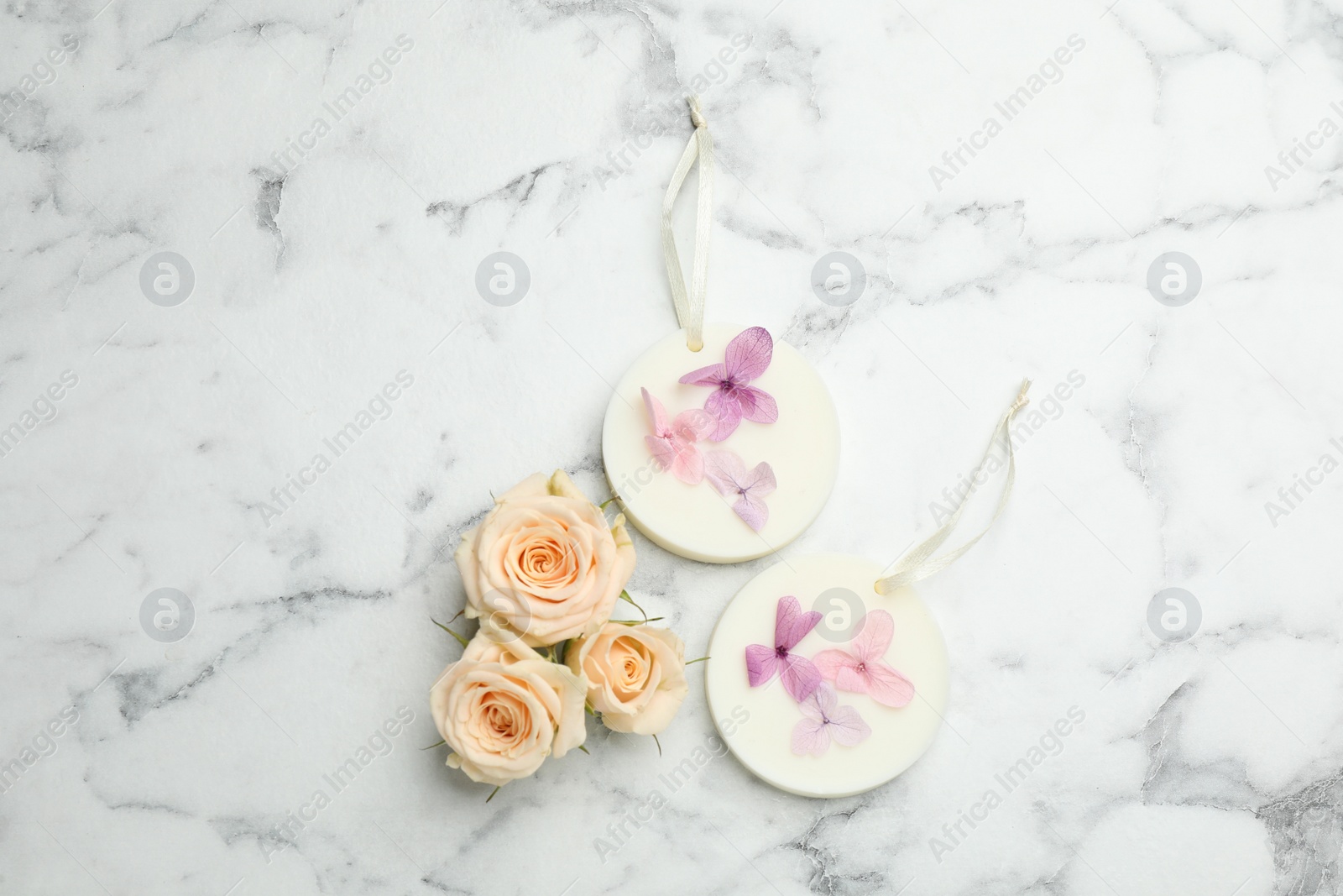 Photo of Flat lay composition with scented sachets on white marble table