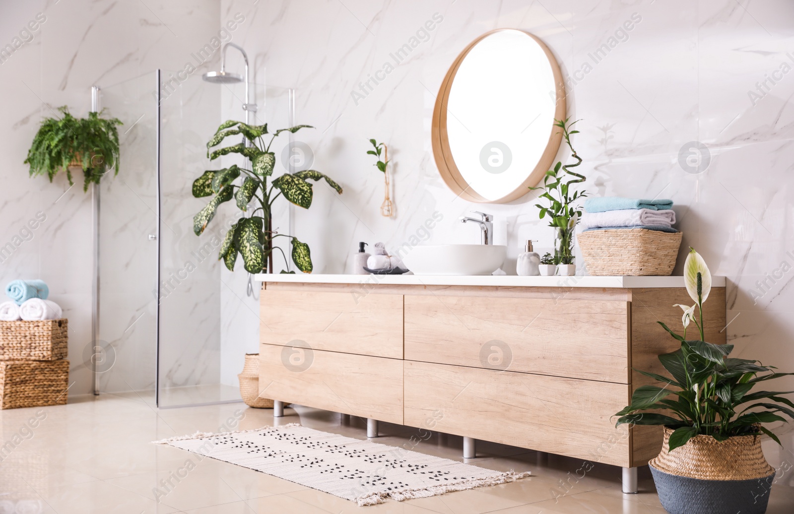 Photo of Green plants in elegant modern bathroom. Interior design