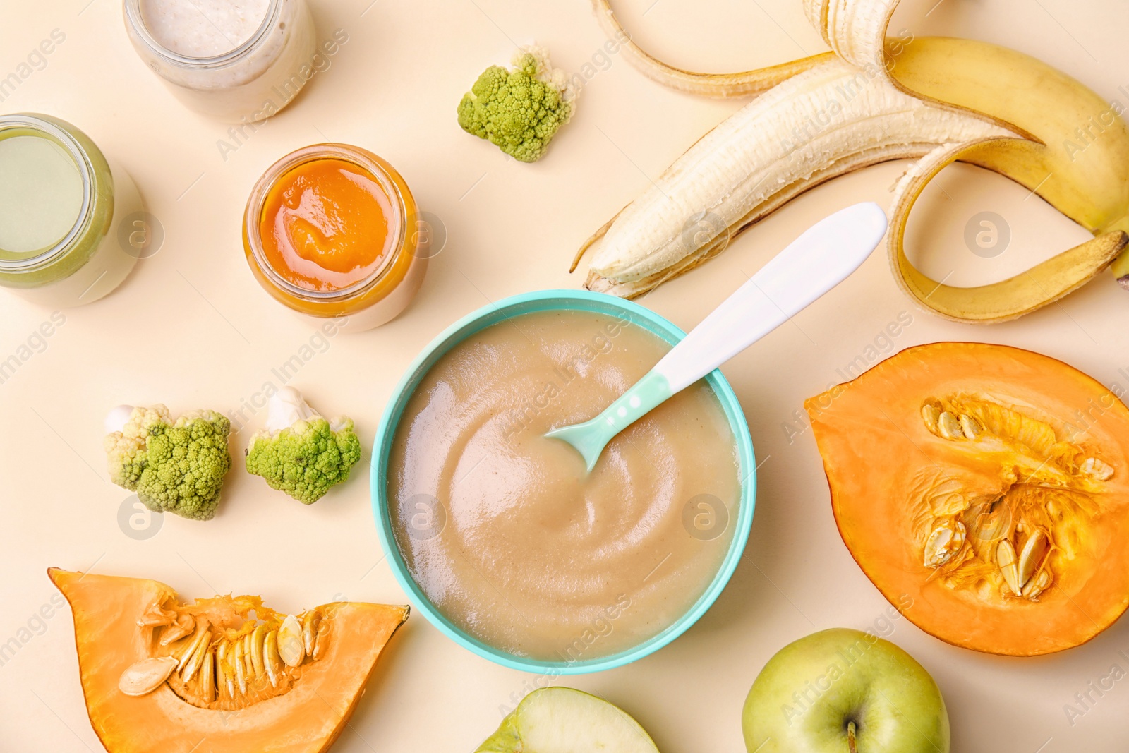 Photo of Flat lay composition with bowl of healthy baby food on color background