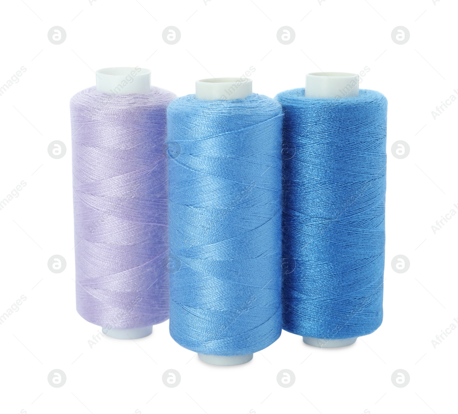 Photo of Different colorful sewing threads on white background