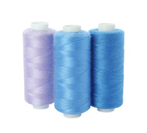 Photo of Different colorful sewing threads on white background