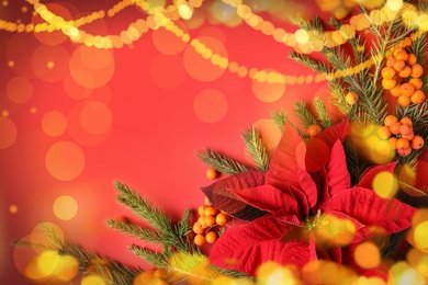 Image of Flat lay composition with traditional Christmas poinsettia flower and space for text on red background, bokeh effect
