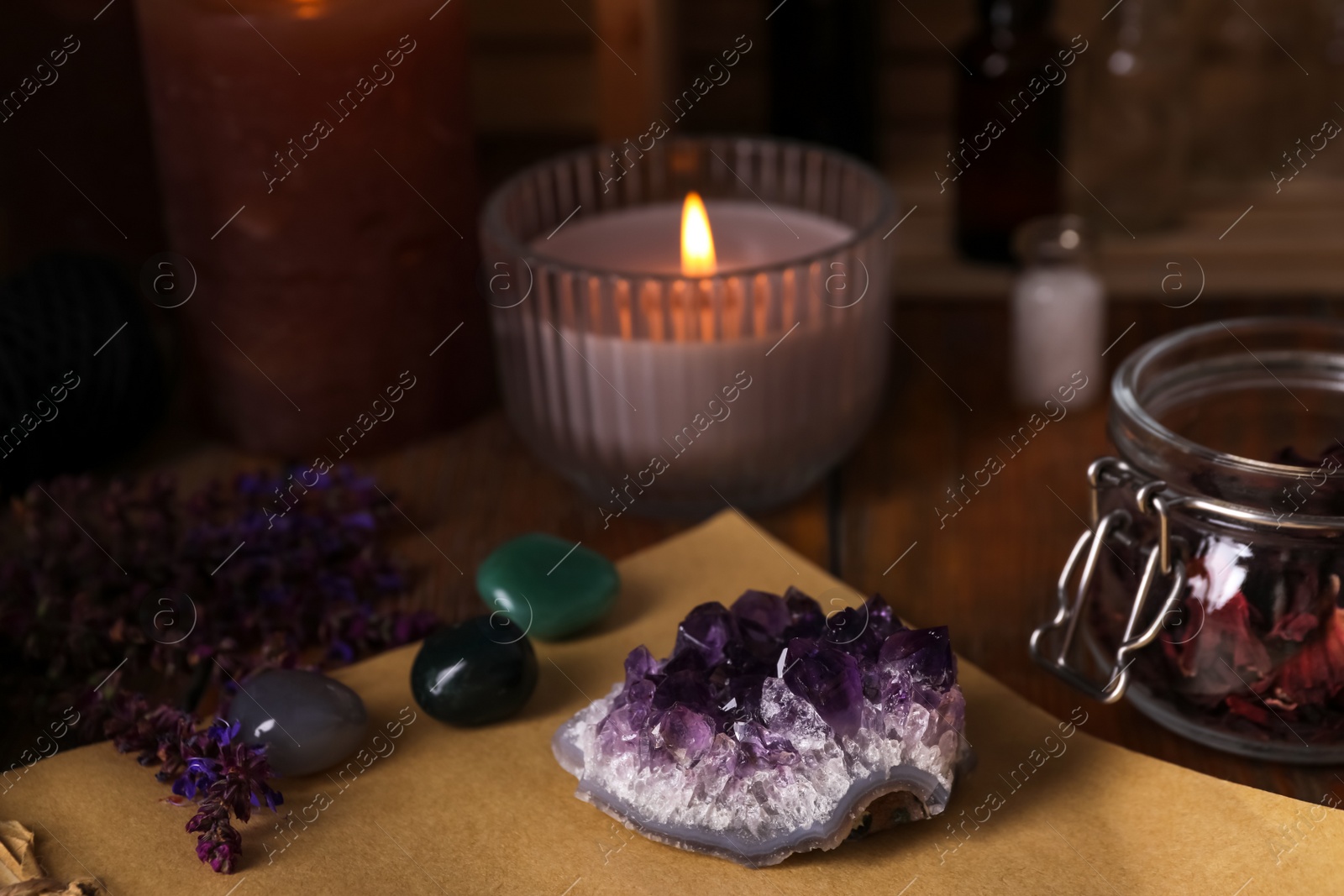 Photo of Composition with healing amethyst gemstone on table