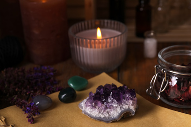 Photo of Composition with healing amethyst gemstone on table