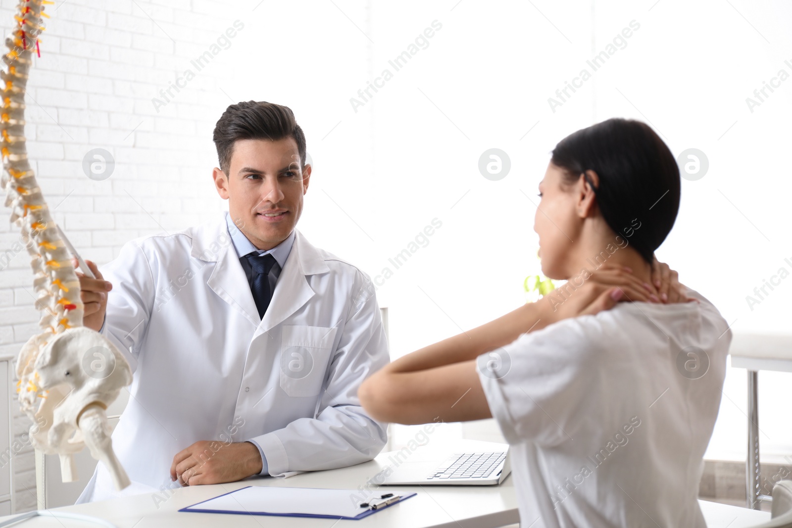 Photo of Young woman visiting orthopedist in medical office