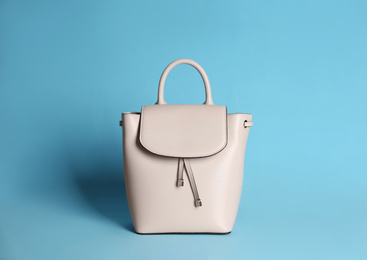 Photo of Stylish woman's bag on light blue background