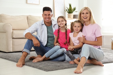 Portrait of happy family on floor at home