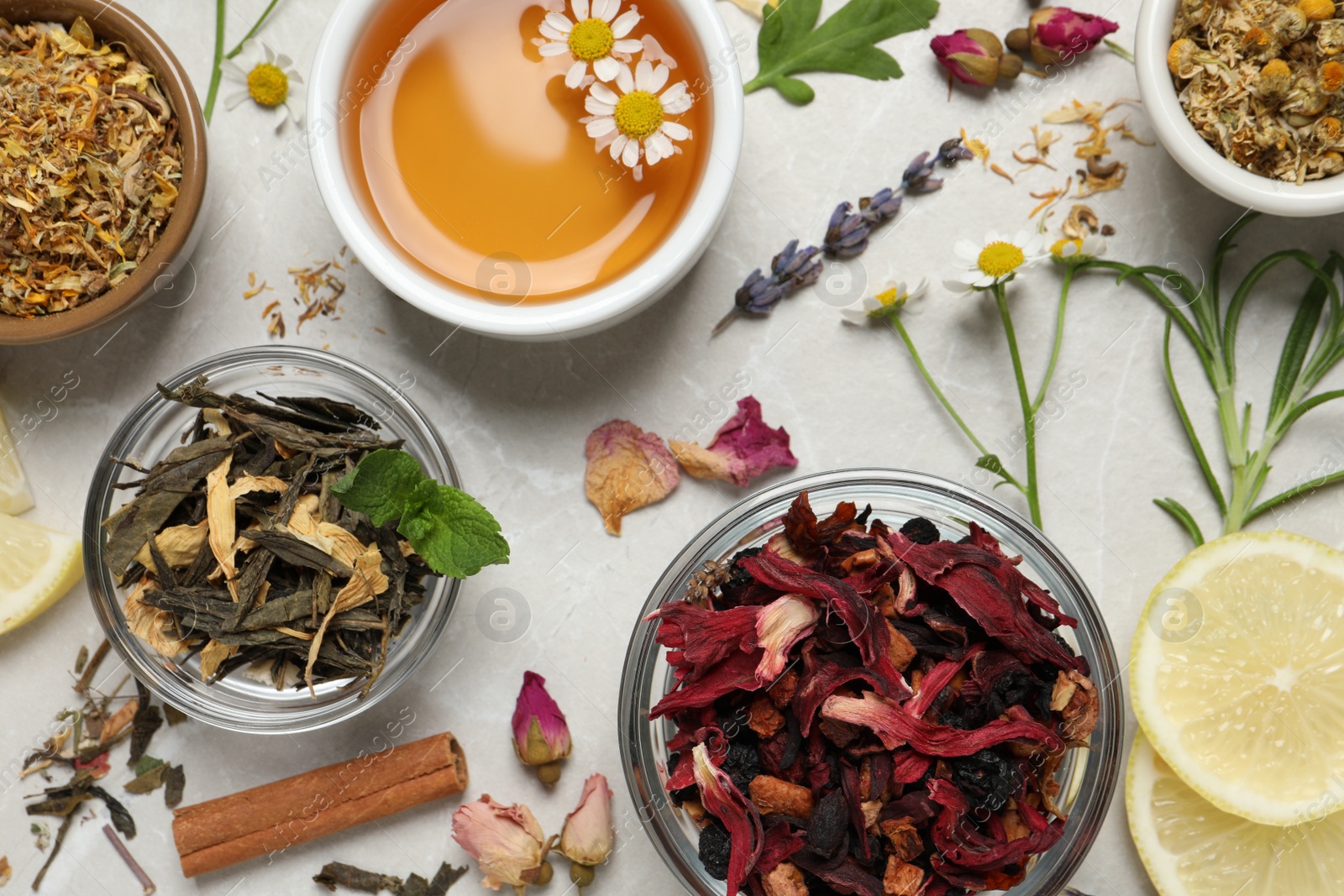 Photo of Flat lay composition with fresh brewed tea and dry leaves on light table