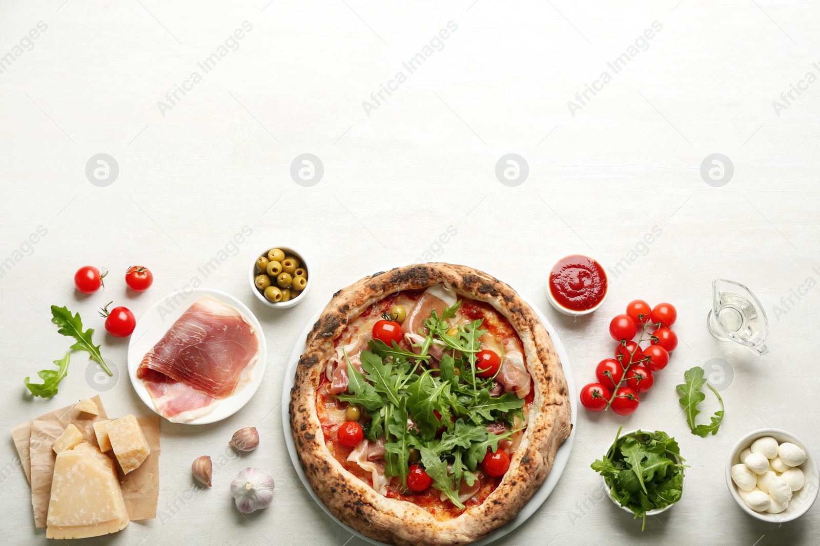 Photo of Tasty pizza with meat and arugula, flat lay. Space for text