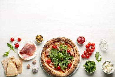 Photo of Tasty pizza with meat and arugula, flat lay. Space for text