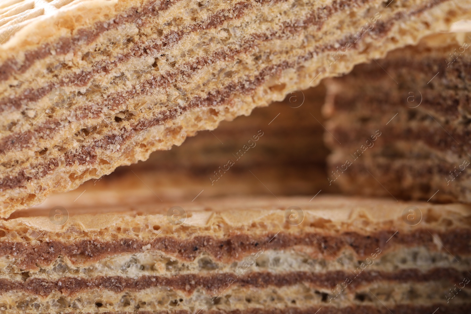 Photo of Delicious crispy wafers with chocolate filling as background, closeup