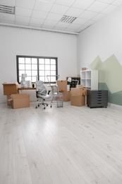 Photo of Moving boxes and furniture in new office