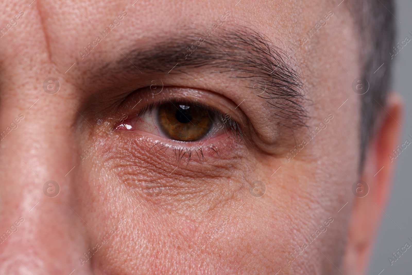 Photo of Closeup view of man with beautiful eyes on grey background