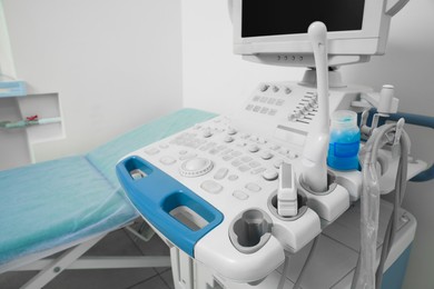 Photo of Ultrasound machine and examination table in hospital, closeup