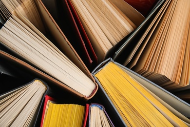 Photo of Stack of hardcover books as background, top view