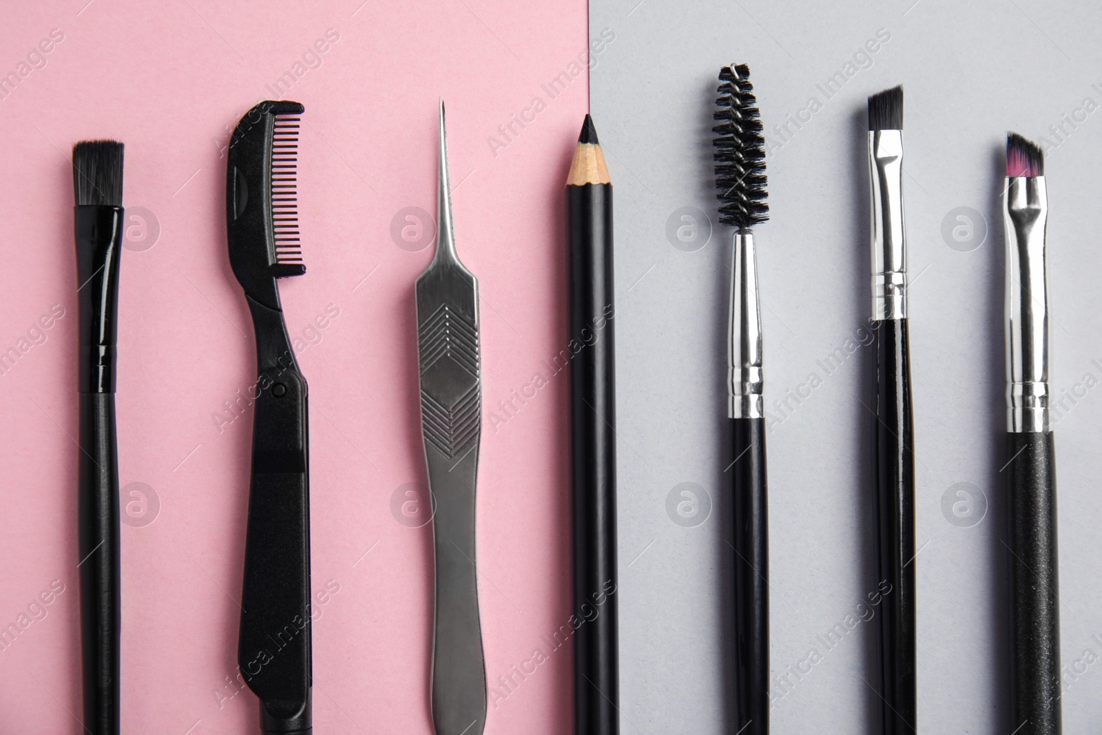 Photo of Set of professional eyebrow tools on color background, flat lay