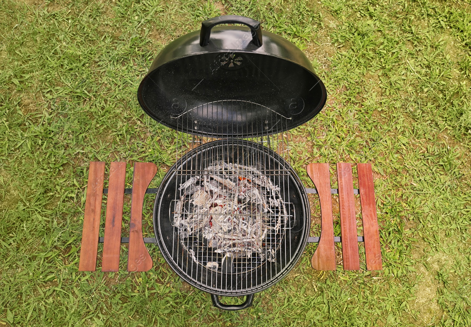 Photo of New modern barbecue grill outdoors, top view. Summer picnic