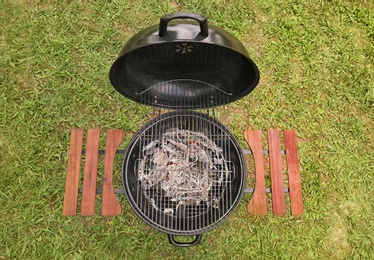 Photo of New modern barbecue grill outdoors, top view. Summer picnic