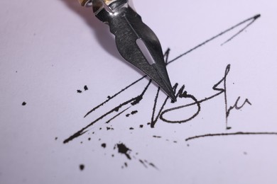 Photo of Signing on sheet of paper with fountain pen, closeup