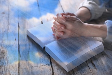 Image of Religion. Double exposure of sky and Christian woman praying over Bible at table, closeup