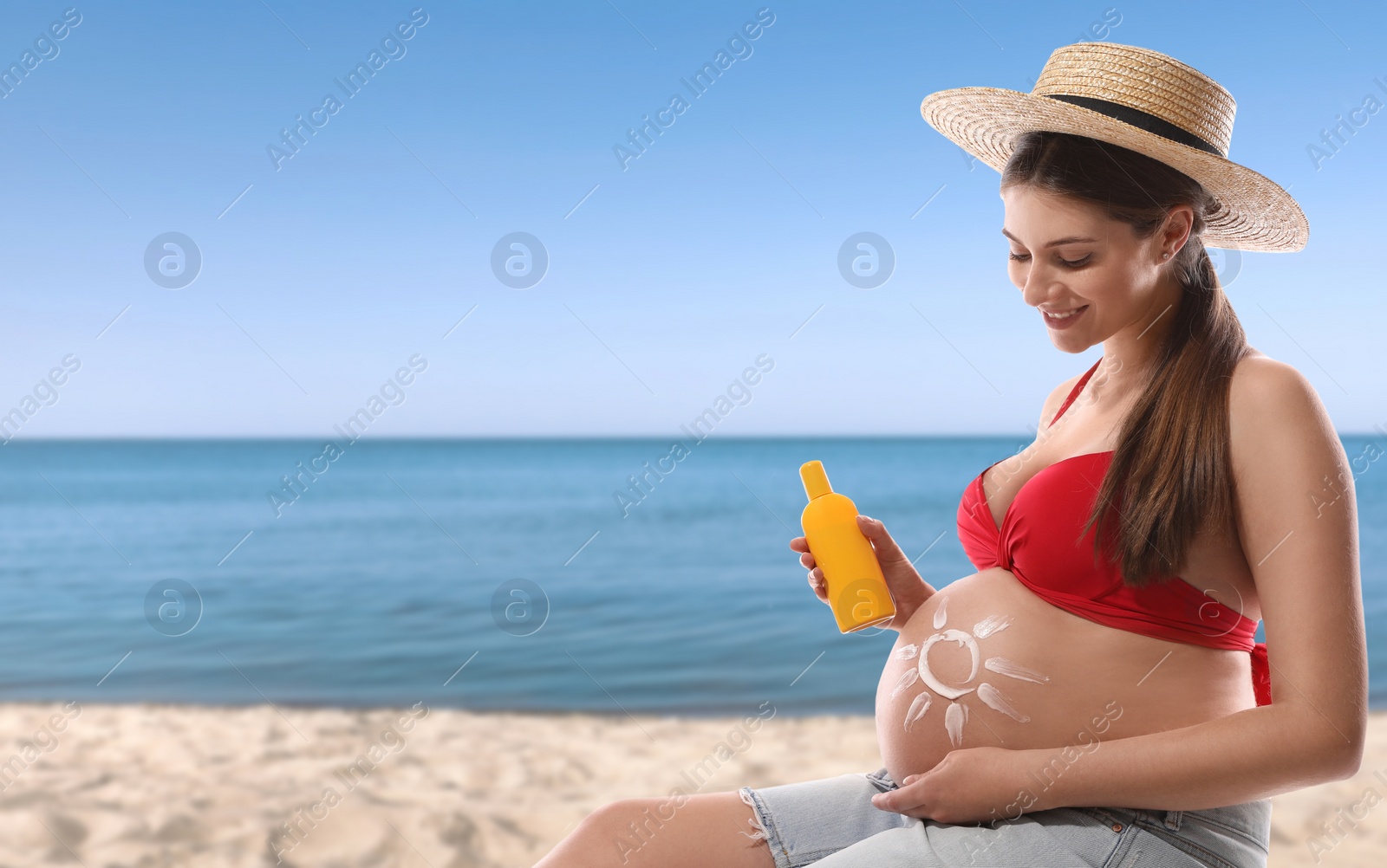 Image of Young pregnant woman with sun protection cream on beach. Space for text