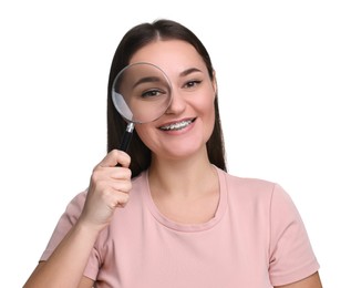 Beautiful woman looking through magnifier glass on white background