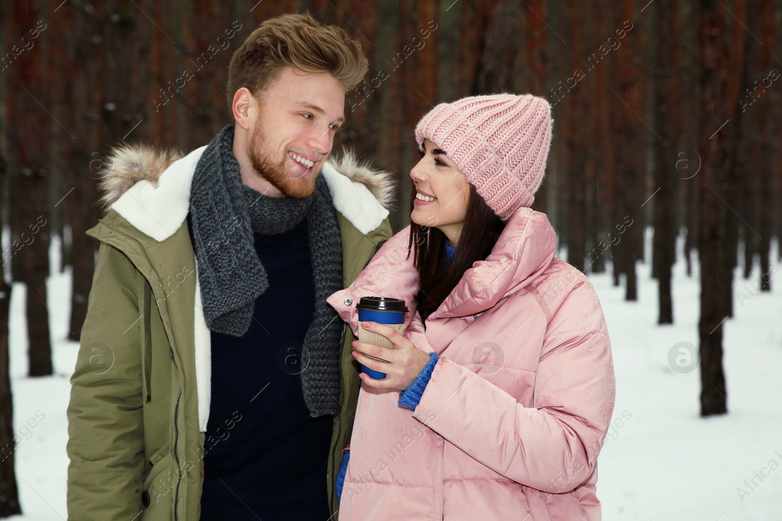 Photo of Beautiful young couple in snowy winter forest