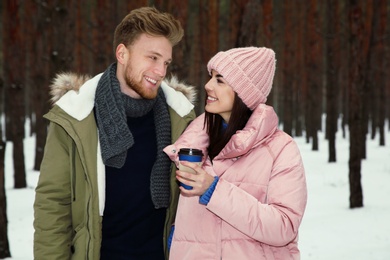 Photo of Beautiful young couple in snowy winter forest