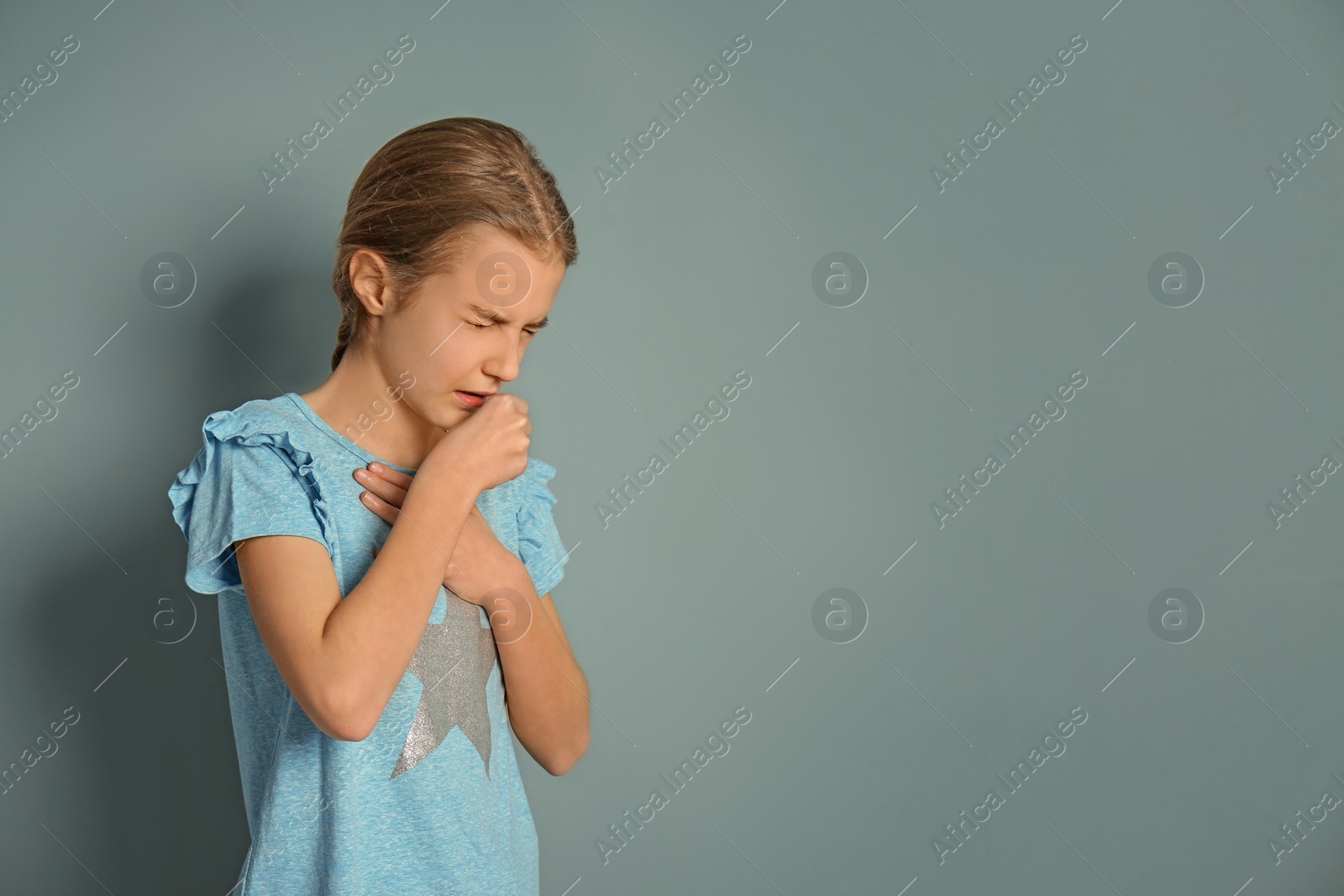 Photo of Girl coughing on color background