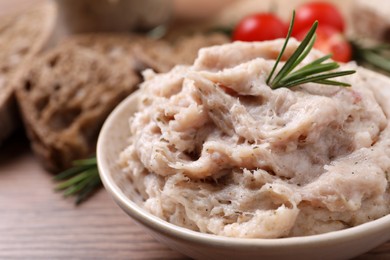 Delicious lard spread in bowl on wooden table, closeup