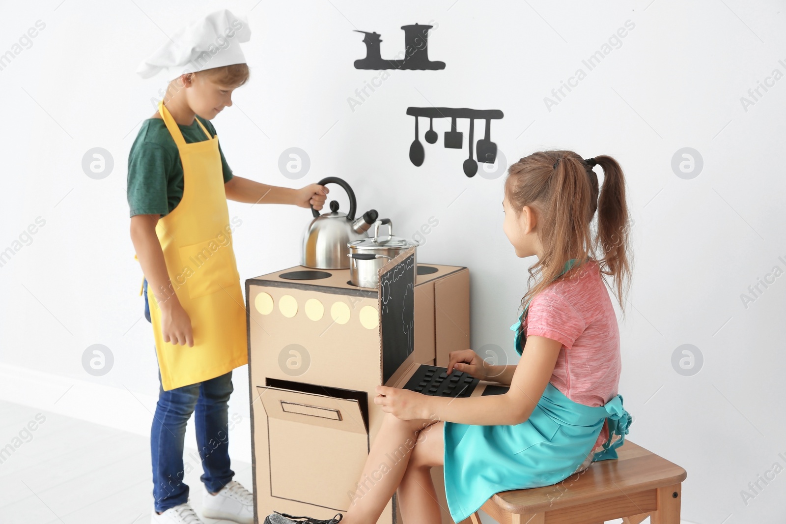 Photo of Little children playing with carton toys indoors