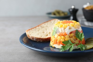 Photo of Delicious fish aspic served on grey table, closeup