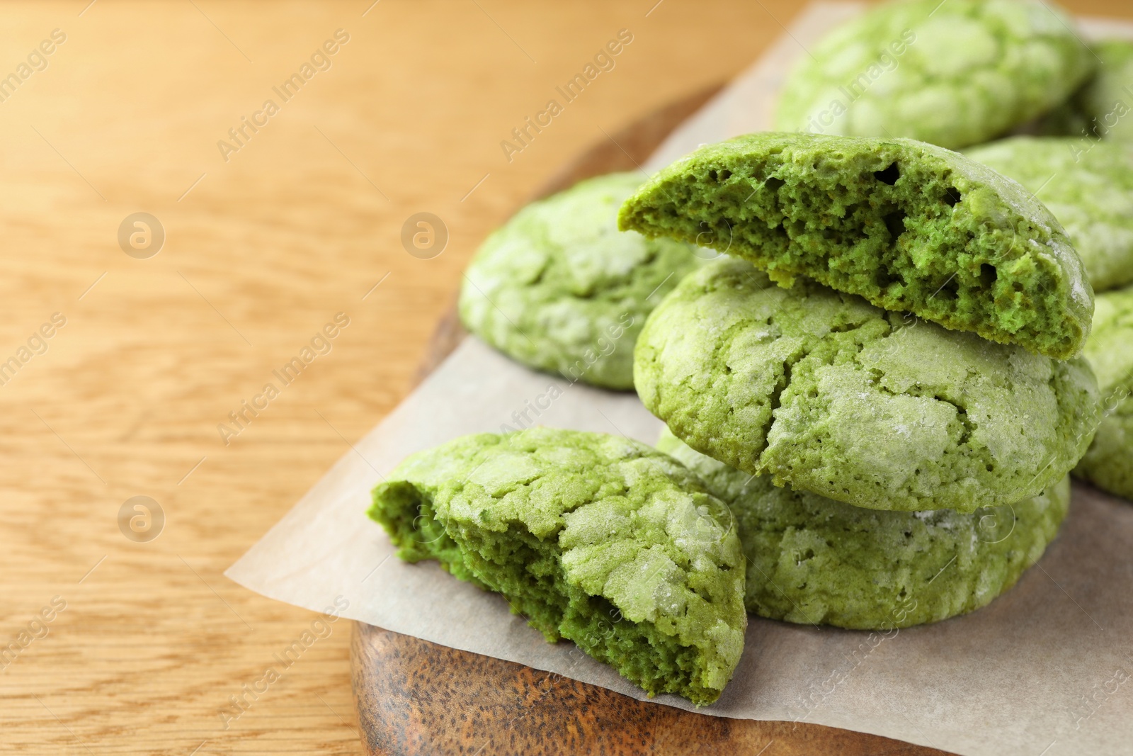 Photo of Tasty matcha cookies on wooden table, closeup. Space for text