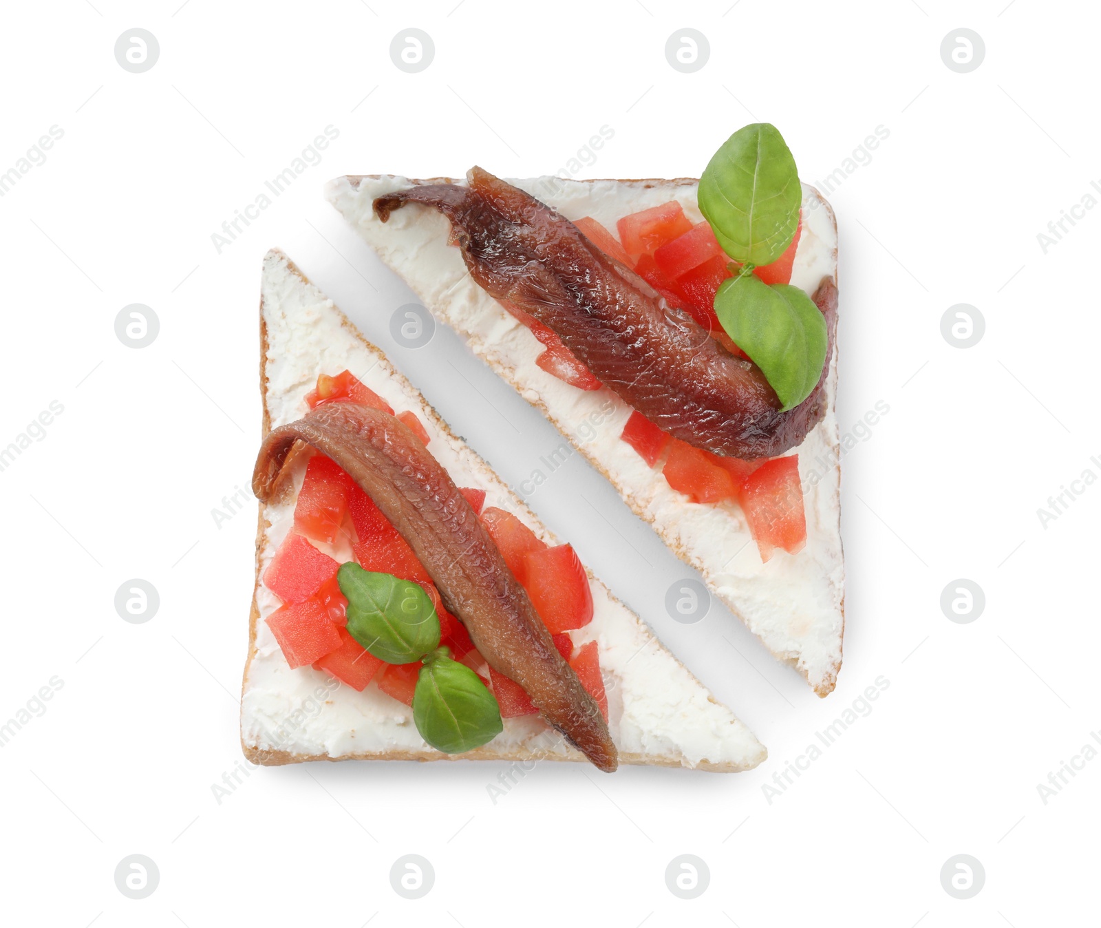 Photo of Delicious sandwiches with cream cheese, anchovies, tomatoes and basil on white background, top view