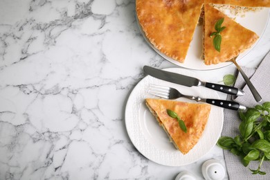 Delicious pie with meat and basil on white marble table, flat lay. Space for text